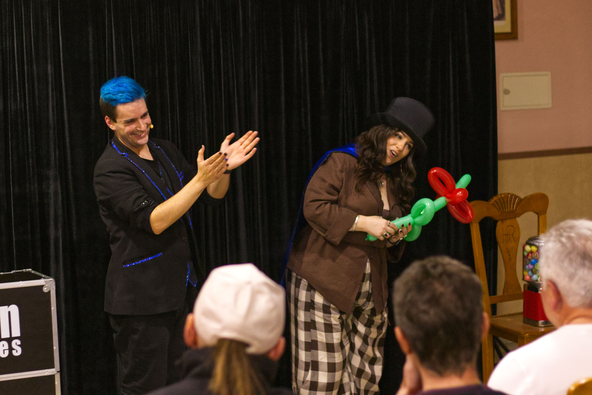 Momento del show donde Ivan Torres - Mago para eventos y empresas está aplaudiendo a una espectadora que ha salido a colaborar con una figura de globoflexia